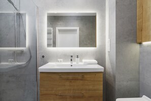 The bathroom's neutral tones create a soothing environment.