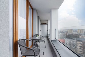 Spacious balcony with outdoor furniture. 