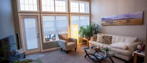 Living room with 14 foot ceiling and access to back deck.