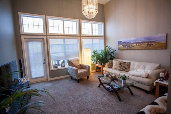 Living room with 14 foot ceiling and access to back deck.