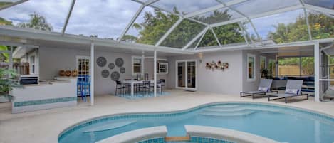 All included is an outdoor kitchen, heated pool and spa, lanai with lots of seating, all enclosed. A professionally landscaped fenced yard.