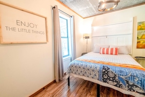 Get cozy in the bedroom with queen bed, separated by a barn door.