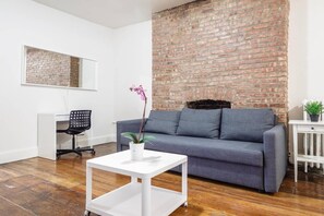 Living room space with Huge sofa with Laptop-friendly workspace!