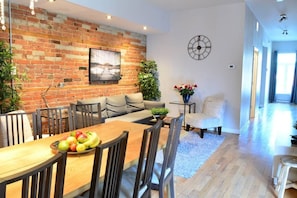 Dining table and living room area with view towards the front of the apartment