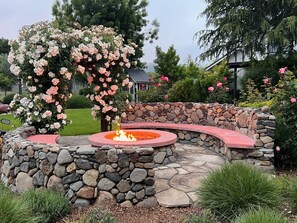 Cozy fire pit by the rose arbor