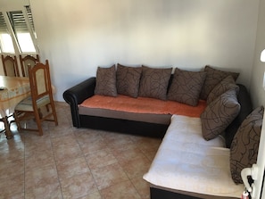 Sofa bed in living area with pull mechanism, where can sleep 2 people.