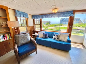 Sea Breeze suite living room with view of beach path and ocean view over the rise.