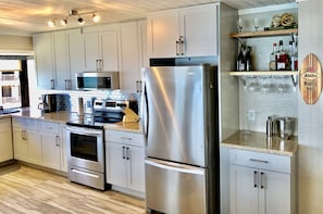 Brand new kitchen with stainless appliances.