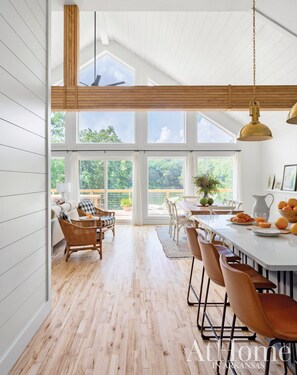 Kitchen looking out into living area with floor to ceiling views of the Lake