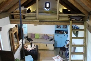 Inside view. Living room, and loft bed on galery.