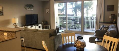 Spacious living/dining area with vews of the beautifully landscaped pool