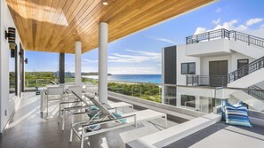 Side ocean views. Hot tub on one side and lounge bed on other side.