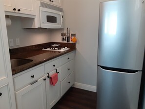 Kitchenette with microwave/convection oven and full refrigerator with freezer