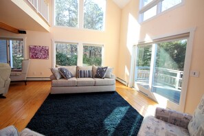 Living room has cathedral ceiling and opens to loft