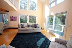 Living room has cathedral ceiling and opens to loft