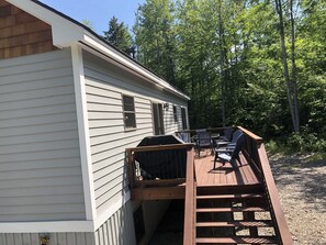 Weber grill, table chairs on the back deck