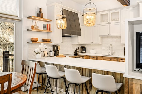 Plenty of seating is found at the dining table and breakfast bar to enjoy dining in during your stay.