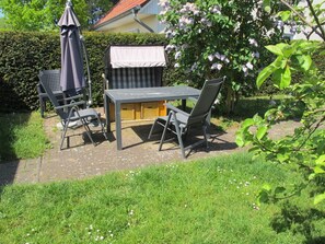 Plant, Property, Furniture, Plant Community, Table, Outdoor Furniture, Chair, Outdoor Table, Shade, Land Lot