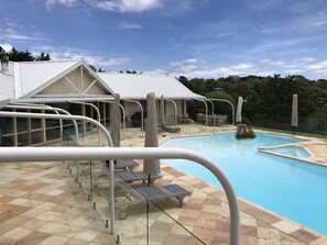Pool secured by glass fence.