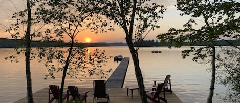 Gorgeous westward view of Peninsula Lake with large dock and a swimming raft. .