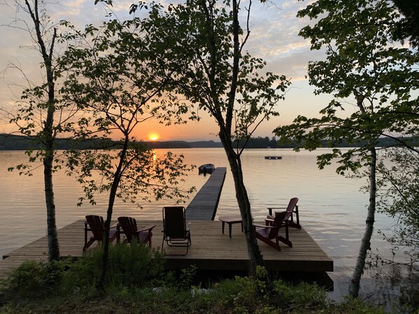 Gorgeous westward view of Peninsula Lake with large dock and a swimming raft. .