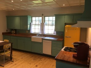 Kitchen: farmhouse sink, dishwasher, gas stove/oven, retro refrigerator.