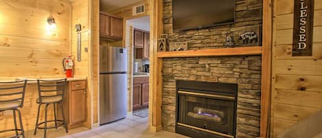 Living area with Stacked Stone Gas Log Fireplace and 43" Smart TV