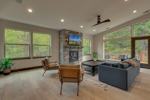 Living area with contemporary furniture, fireplace, and flat screen tv