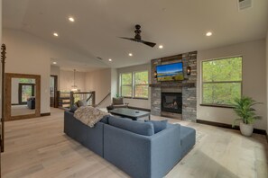 Living area with contemporary furniture, fireplace, and flat screen tv