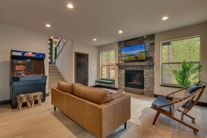 Recreation room with arcade, seating area, and flat screen tv