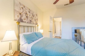 Front Bedroom with TV and ceiling fan.