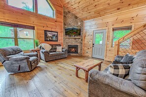 Living room with high ceilings and seasonal gas fireplace