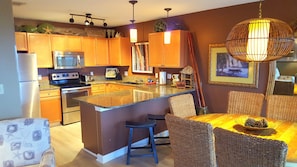 Kitchen and dining.  Notice the new hardwood floors.