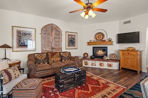 The living area is modern with a rustic flair and southwestern charm
