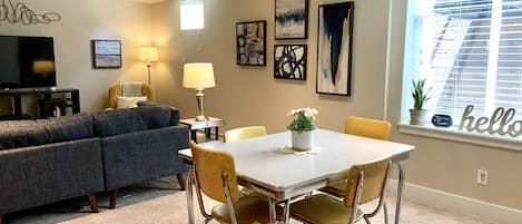 A bright light-filled basement guest suite with retro seating for 4.