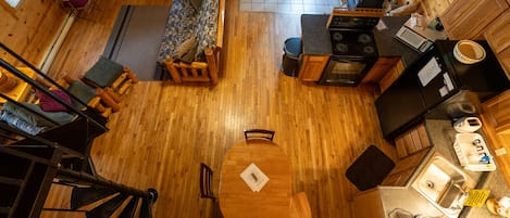 Looking down from loft into kitchen and living room 