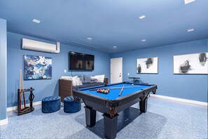 5th Bedroom/Game room: two twin trundle beds (4 twins total), pool table and flat screen TV - photo verified by Airbnb