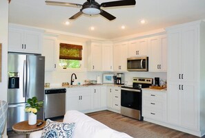 Fully stocked kitchen with refrigerator, stove/oven, microwave and dishwasher.