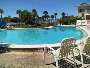 Spacious heated Pool. Upham Beach/Gulf of Mexico is just behind the tall palms.