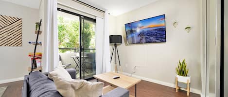 Living Room with 55" Roku Smart TV out onto Balcony