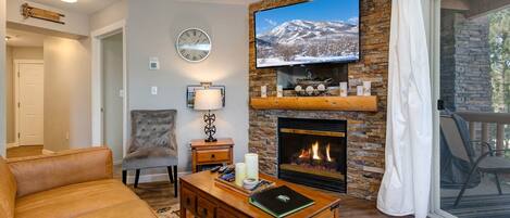 1808 W Fox Bay Dr #B103_08: Cozy setup with a sleek sofa, center table, and stoned fireplace.