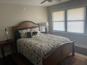 2nd bedroom with ceiling fan and flat screen TV.