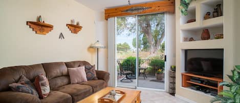 Living room has large floor to ceiling sliding doors, with view of GC. 