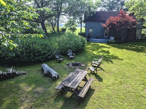 Side yard with patio, fire pit, picnic table and more
