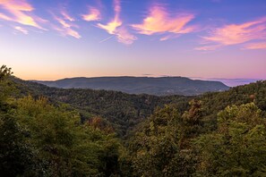 Watch layers of mountains fade into soft blues and purples