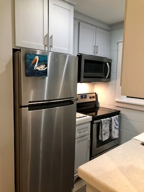 Newly redone kitchen with quartz counters, tons of storage and fully equipped!