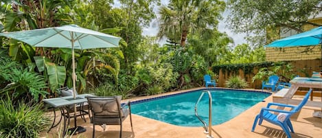 The private, heated pool and deck is surrounded by lush tropical landscape.