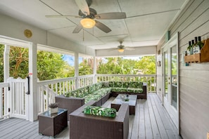 This breezy porch overlooks the tropical pool.