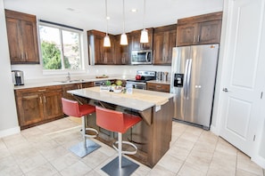 Clean and well equipped Kitchen with an Island Top Counter
