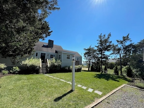 View of the house from the driveway, your stay at the beach awaits.